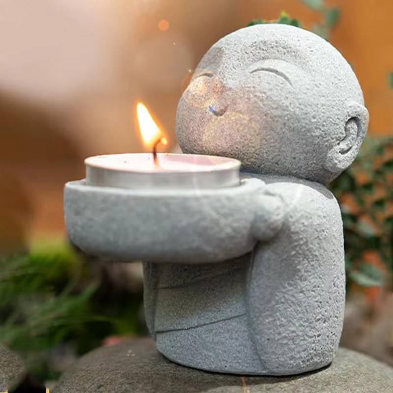 Cute buddha candle holder with lit tealight candle