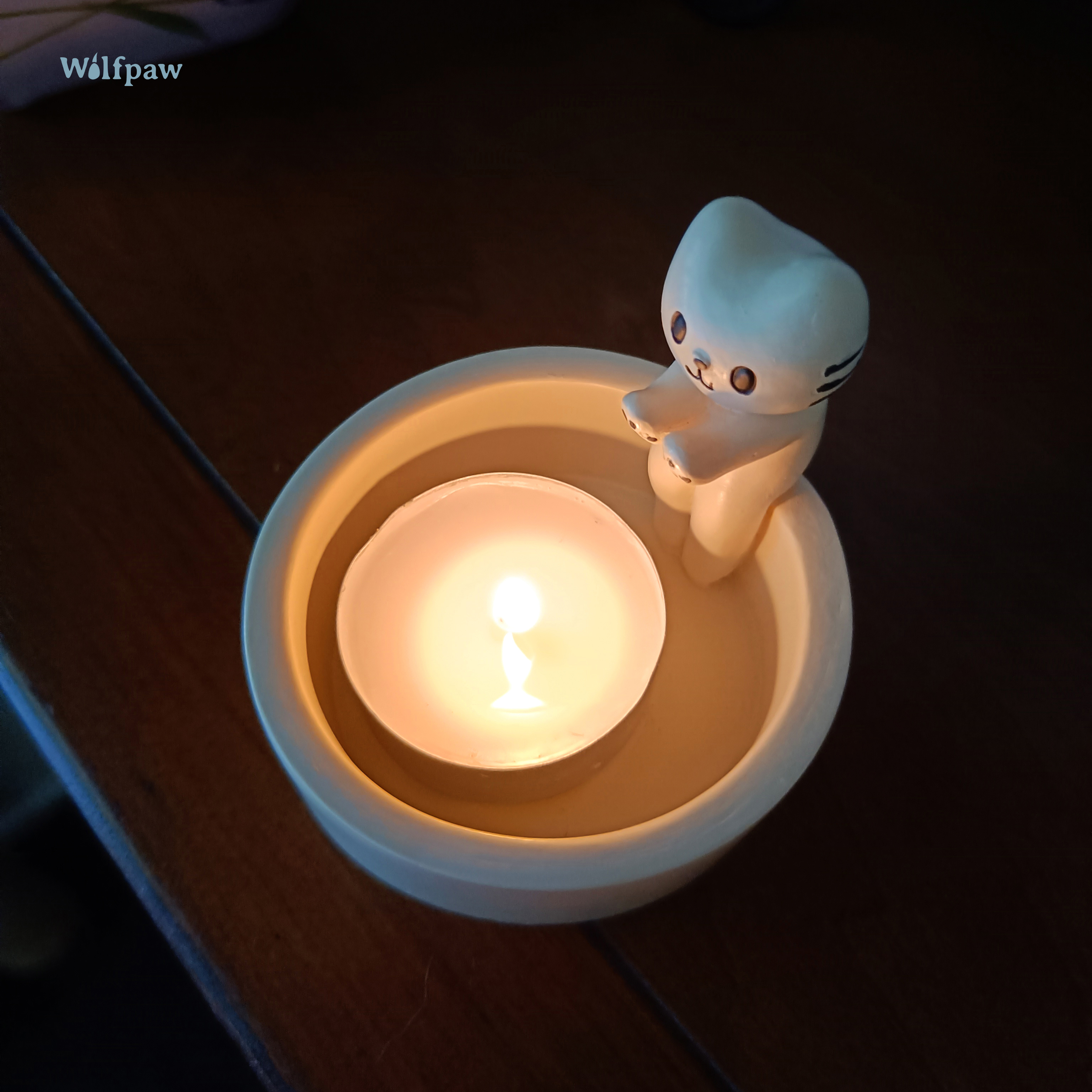 Candle holder featuring a playful cat design