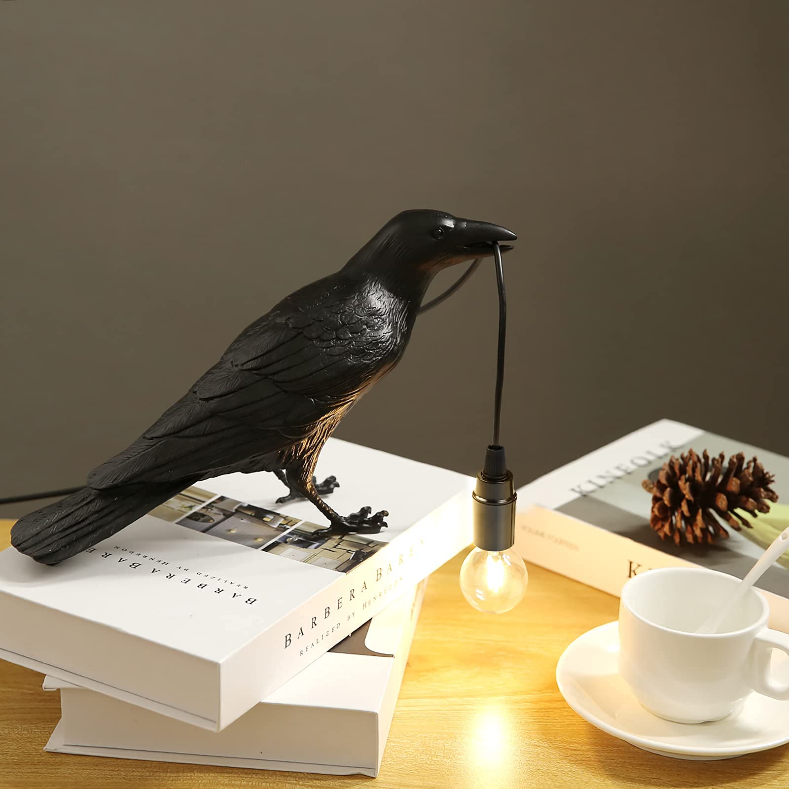 Crow holding a lit light bulb whilst stood on multiple books