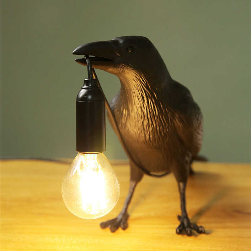 Close up shot of a crow holding a light fixture with its beak