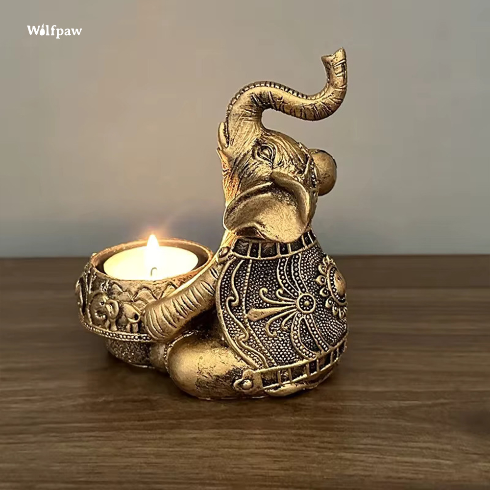 Elephant candle holder sitting down and holding a tealight