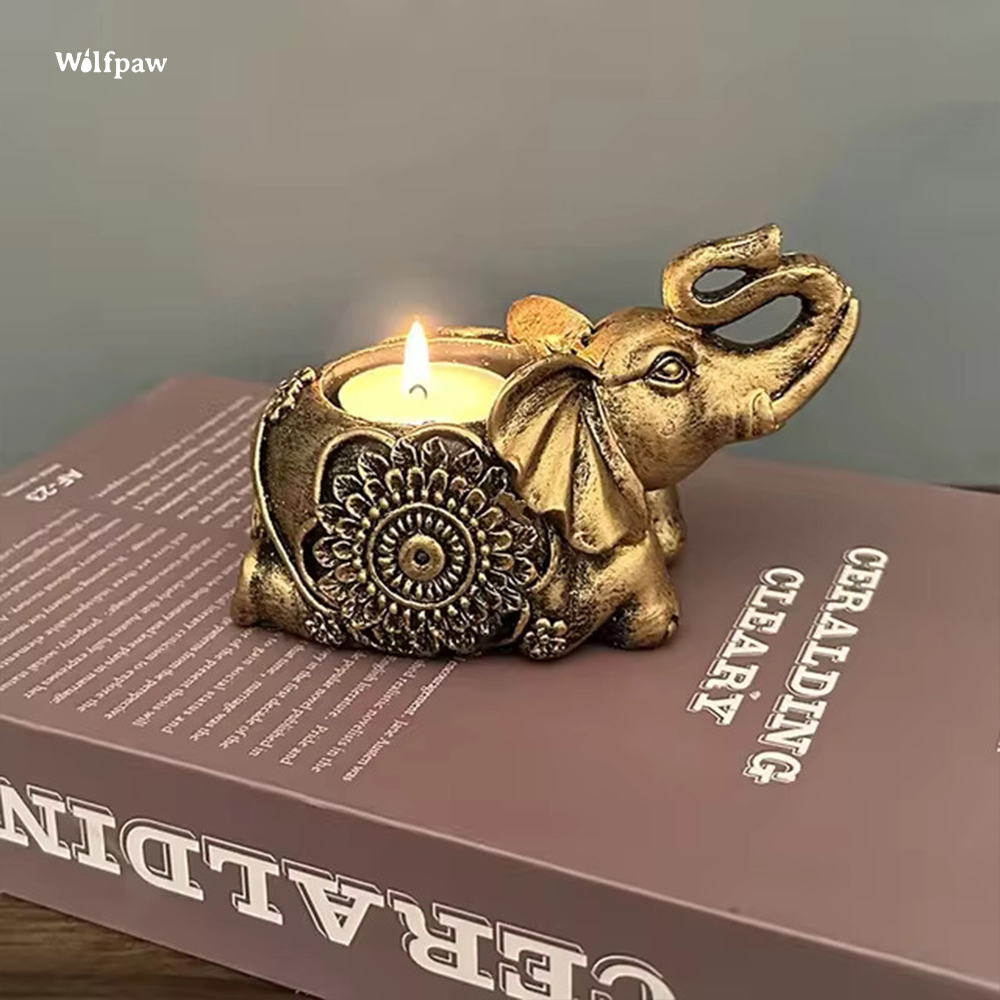 Elephant candle holder laying down and holding a tealight