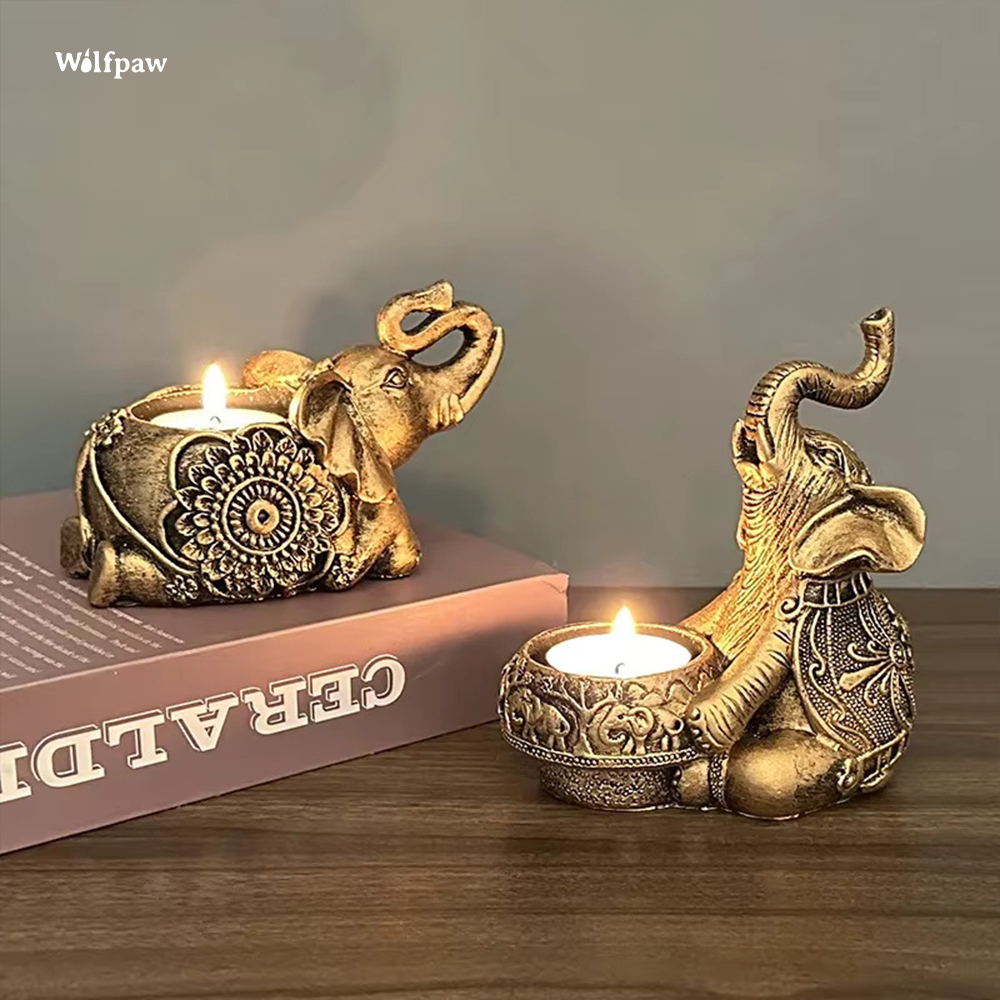 Image showcases a set of two elephant candle holders