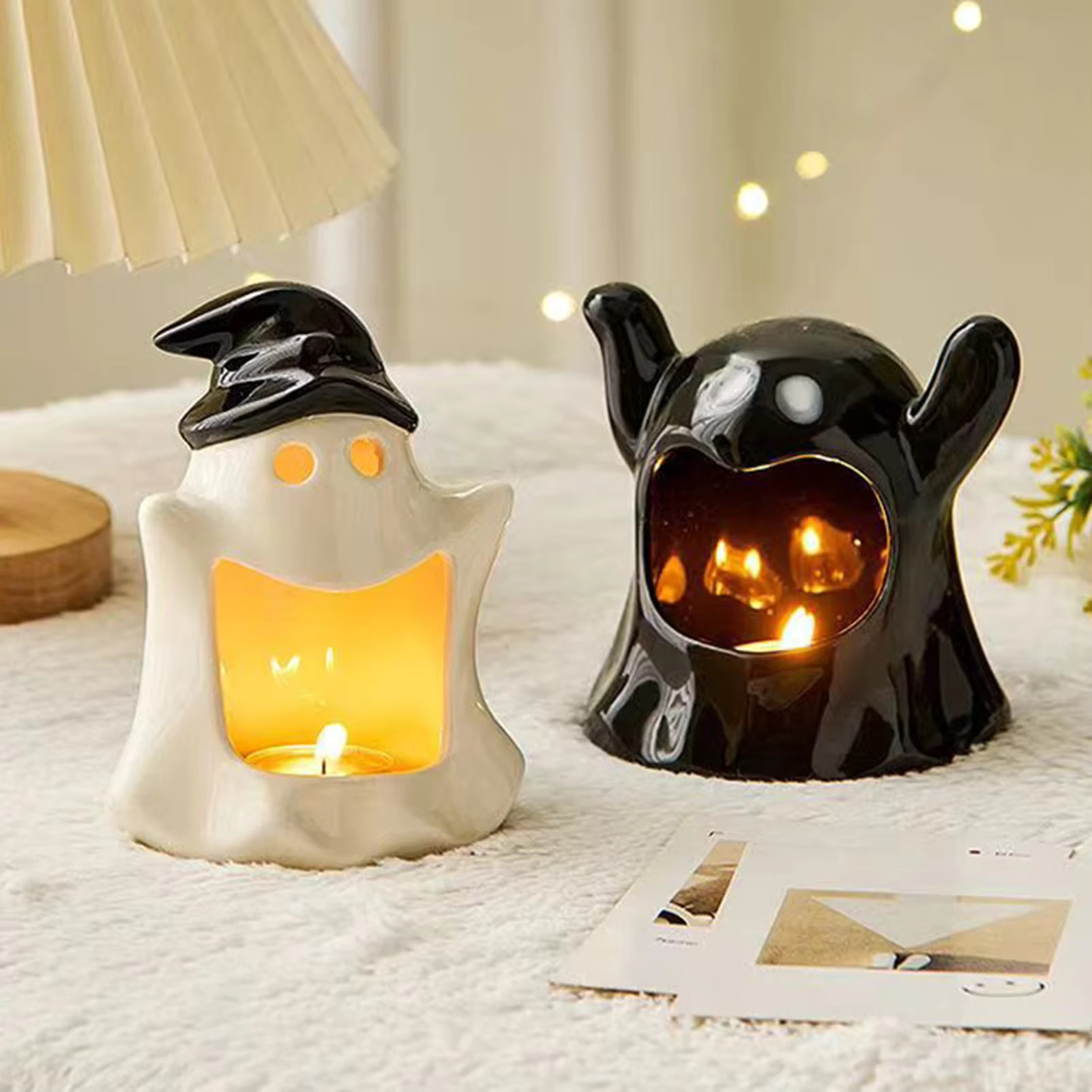 Two ghost's one with a witch hat and one black candle holder set