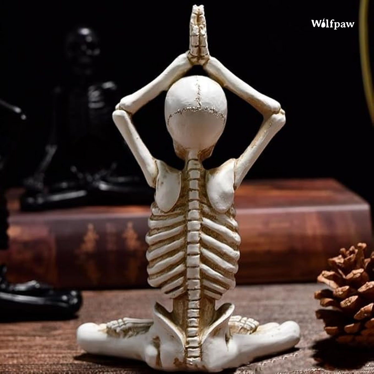 A skeleton in a yoga pose sits cross-legged on a table, embodying tranquility and mindfulness in a unique setting.