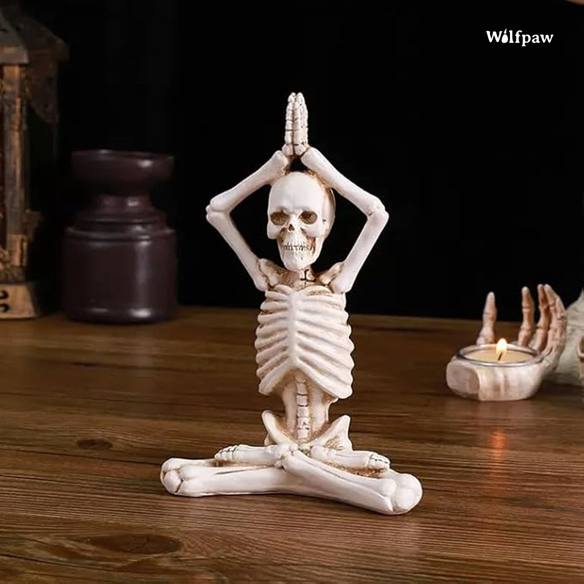 A skeleton in a yoga pose sits cross-legged on a table, embodying tranquility and mindfulness in a unique setting.