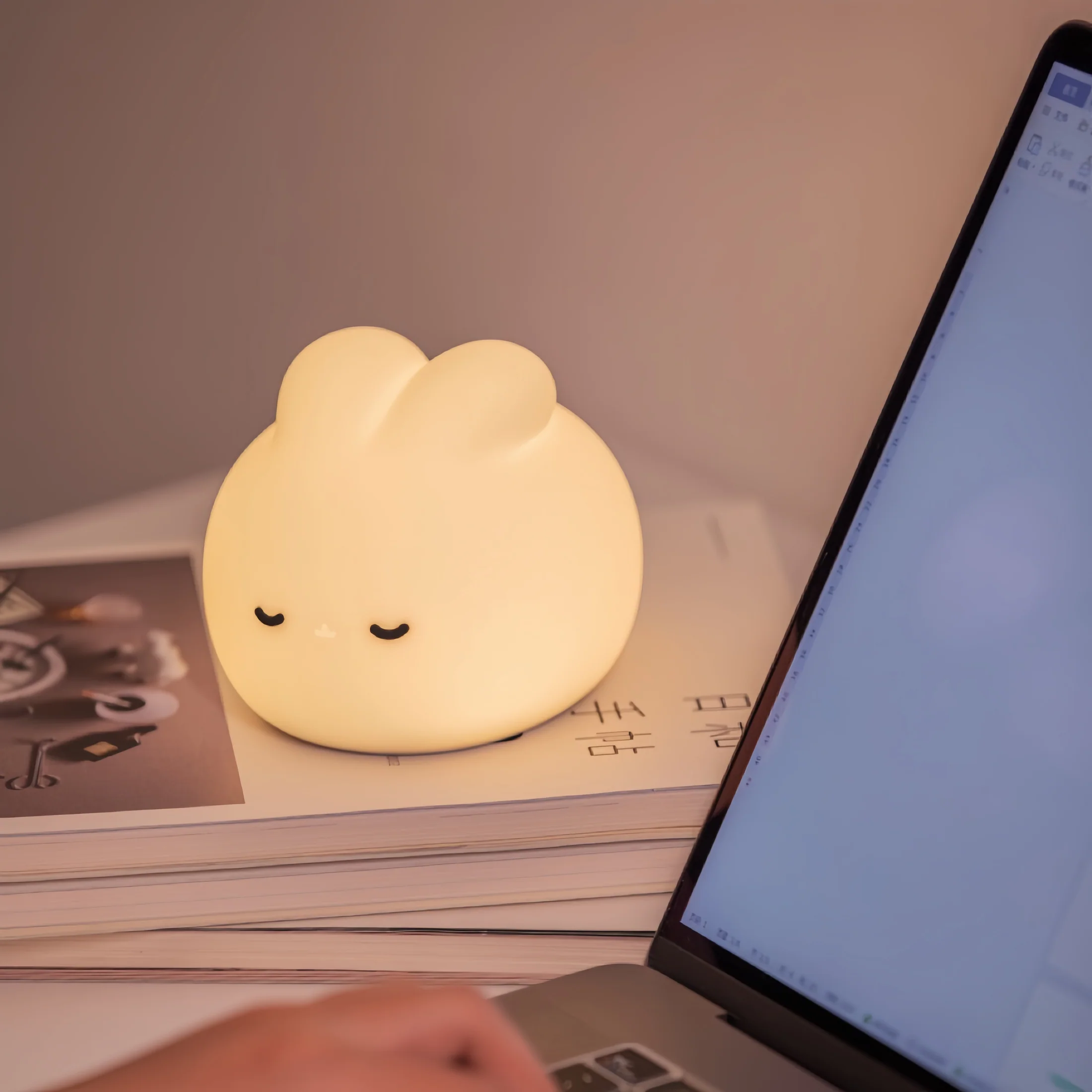 Lifestyle shot of Sleepy bunny night light in a cozy bedroom setting