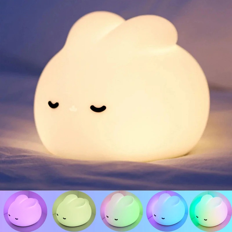 Front view of Sleepy bunny night light on a bedside table