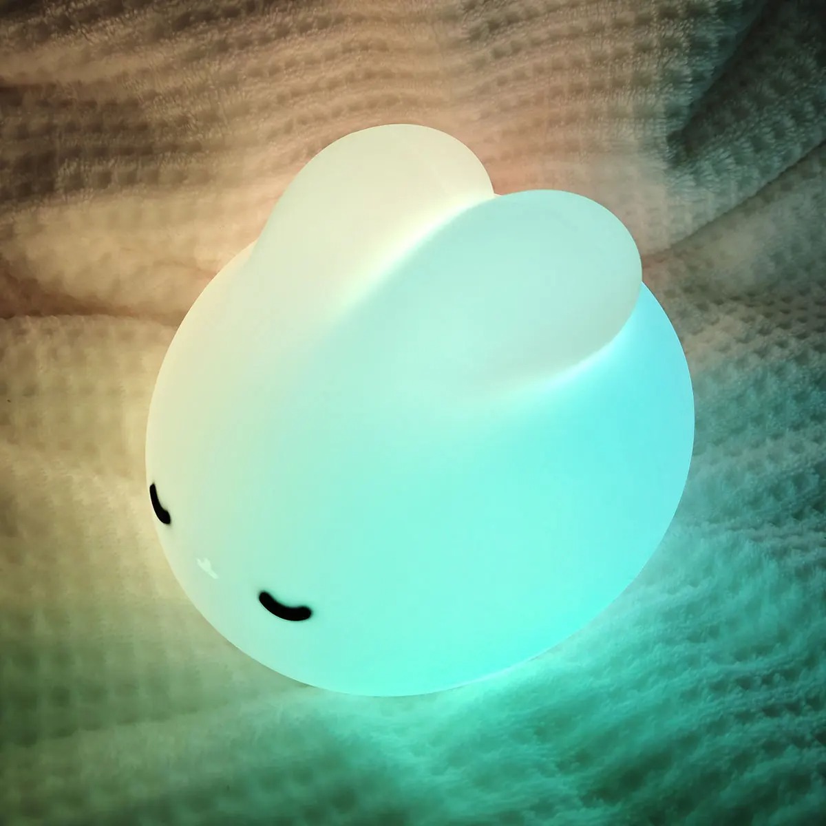 Sleepy bunny night light being tapped to adjust brightness